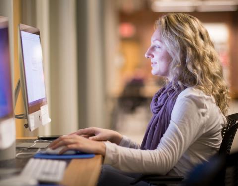 UNH Graduate Student using a computer